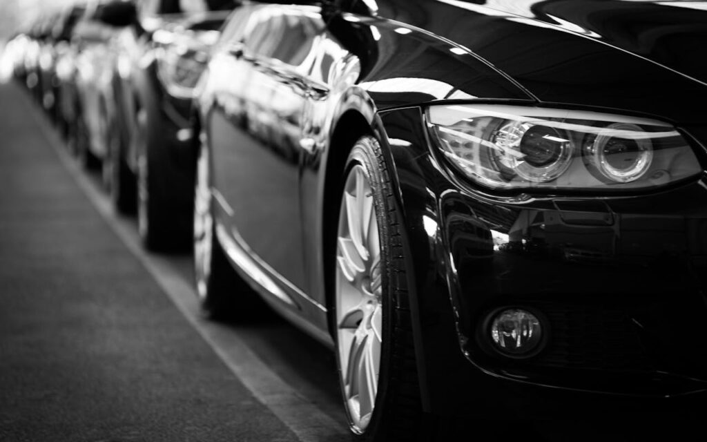 pexels-photo-70912 Close-up black and white image of a luxury car line-up focusing on vehicle headlights.